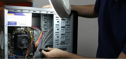 Computer repair man reparing a desktop pc